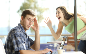 man is ignoring woman who is trying to reach out to him but he does not respond