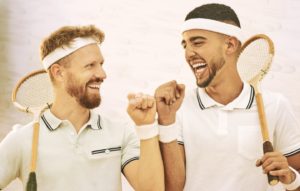two men playing pickleball or tennis who have a connected friendship