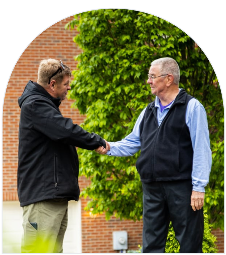 Lawn franchise owner shaking hands with happy customer